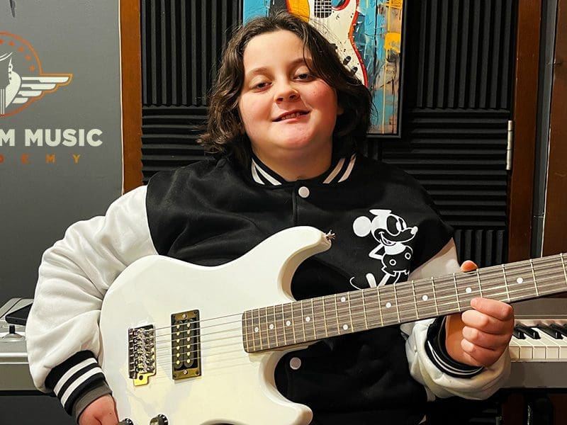 Guitar Lessons at Freedom Music Academy - Johnson City Tennessee 2 Young students playing musical instruments in group setting in Johnson City Tennessee at Freedom Music Academy
